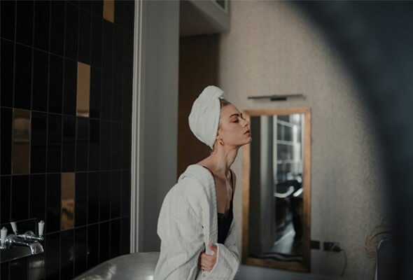 lady after shower using filter for showerhead