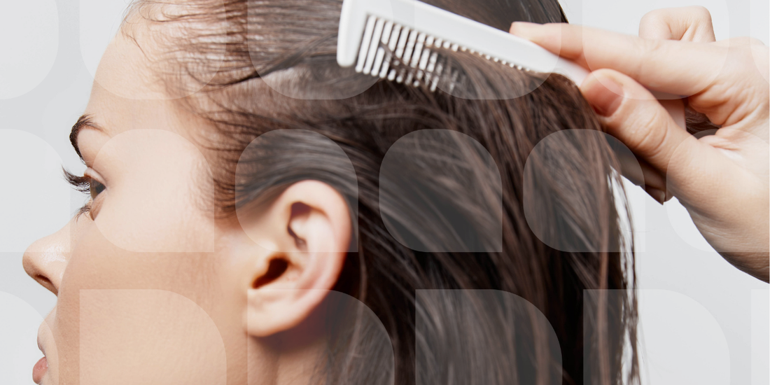woman combing her wet hair