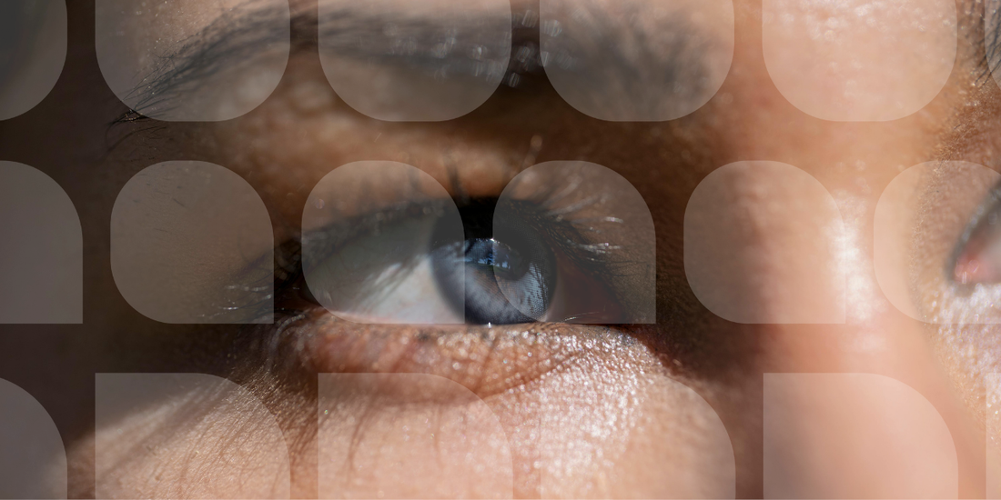 close up of a womans blue eyes looking up