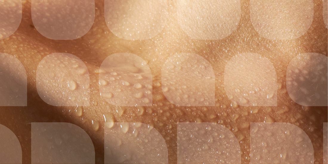 close up of womans collar bone covered in water droplets