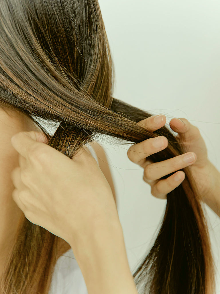 Close up image of womans hair being plaited