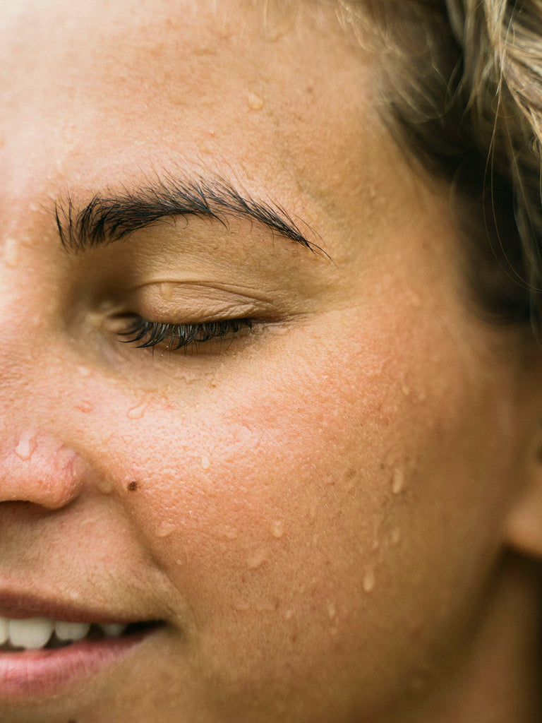 Close-up of a person's face with visible wet on skin