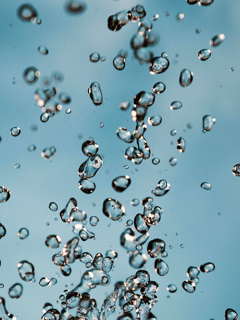 Close-up of water bubbles against a blue background