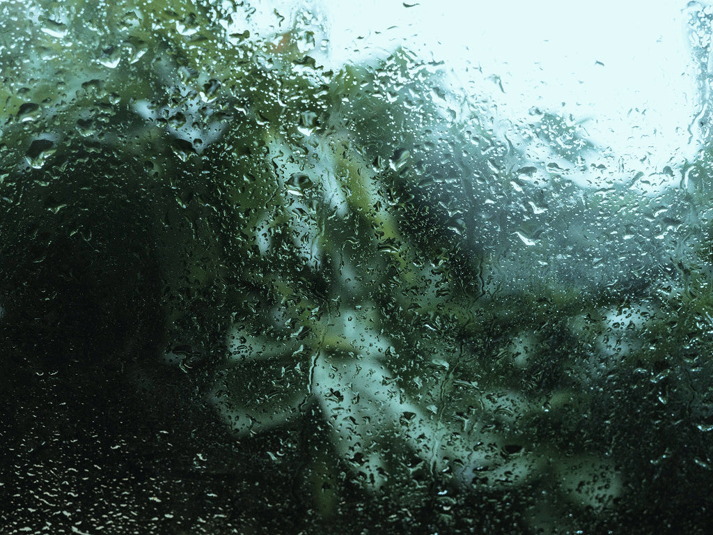 Close-up of a glass screen with water droplets 