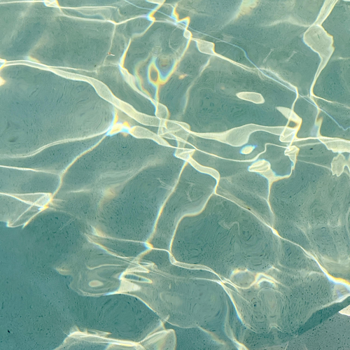 Close-up of water surface with ripples and reflections