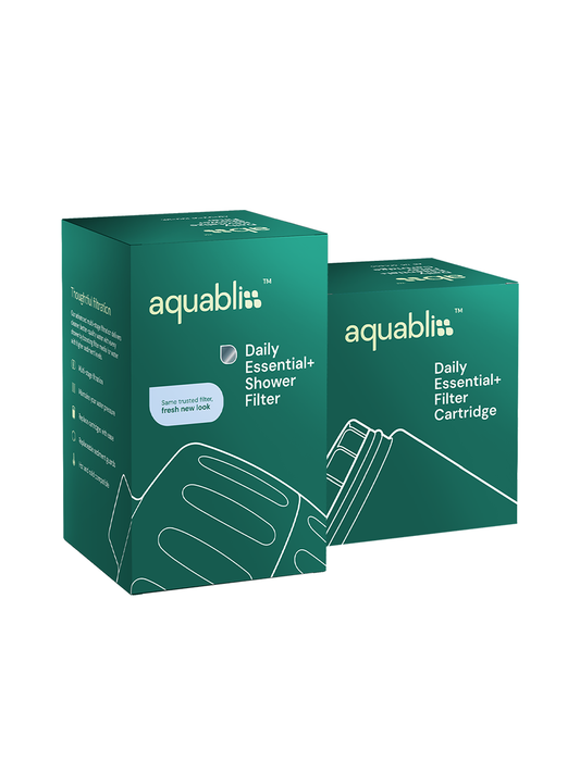 Two teal-green Aquabliss Daily Essential+ Shower Filter boxes on a plain white background, with one box in front and one behind it.