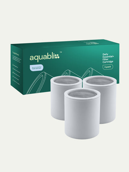 Three white filter cartridges in front of an Aquabliss branded box on a white background