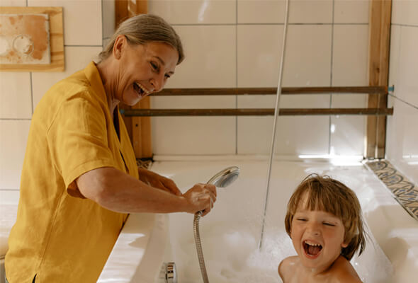 happy parent using kids showerhead