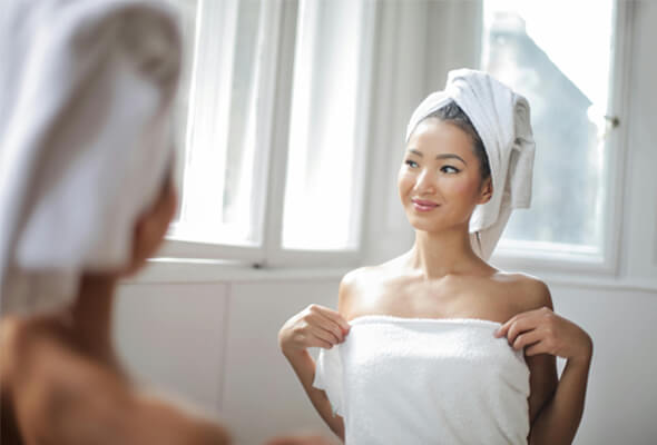 happy woman after using shower filter for acne