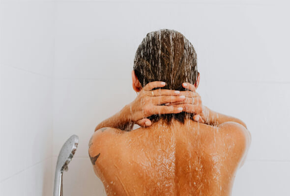 lady taking shower with mineral shower filter