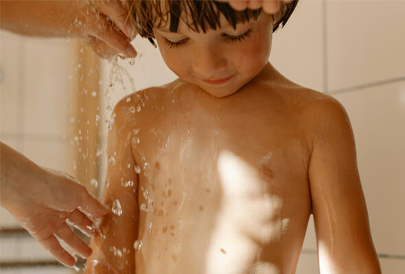 parent assisting kid taking shower