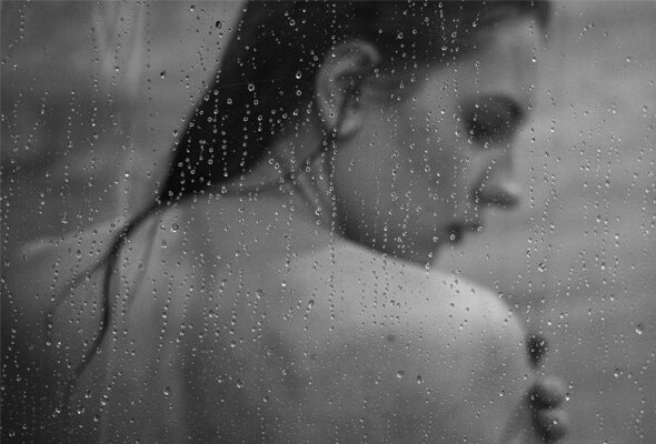 woman having shower using flexible showerhead