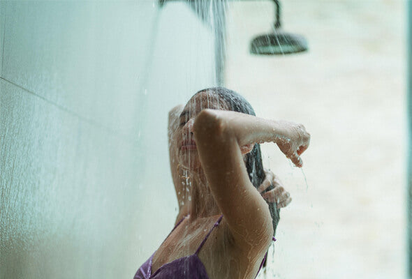 woman taking shower with mineral shower filter