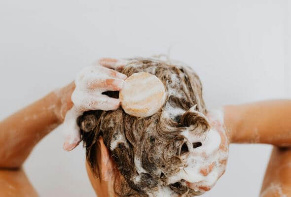 woman taking shower with shower filter for blonde
