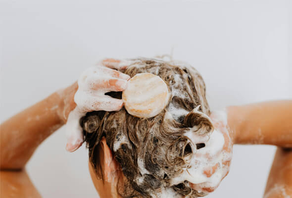 woman taking shower with high power showerhead