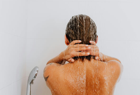 woman using showerhead for low water pressure