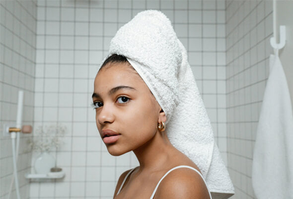 young lady after shower using iron shower filter